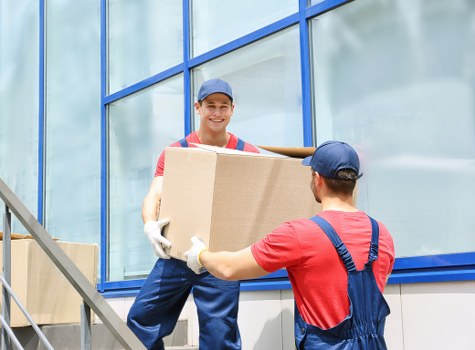 Removal team planning a local move in Catford with packed boxes and a van